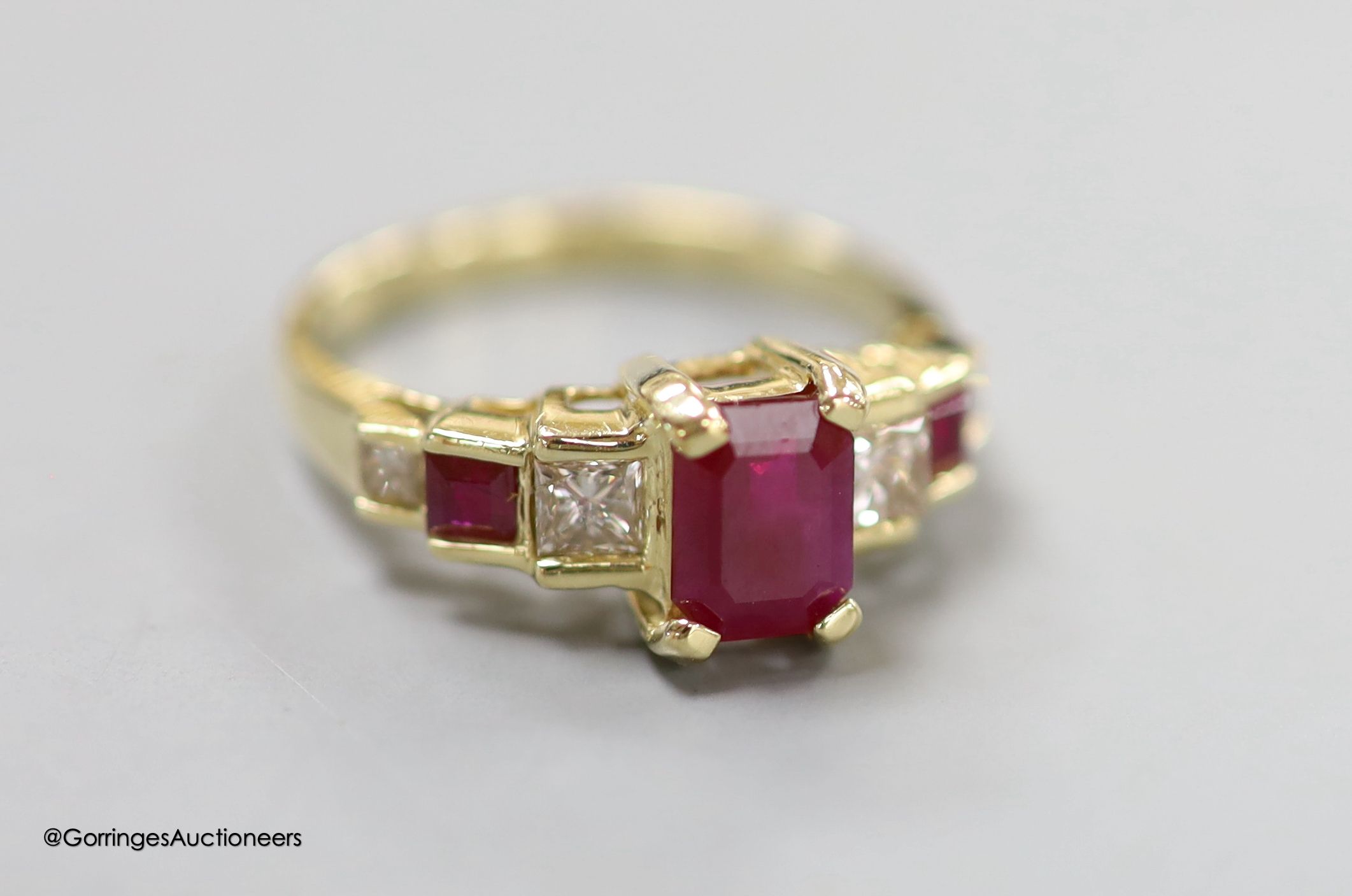 A modern 14k, ruby and graduated ruby and diamond set seven stone half hoop ring, size N, gross 3.6 grams.